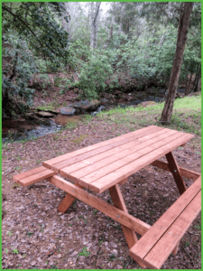 Basic campsite by the creek with picnic table is one of the amenities at Grand View